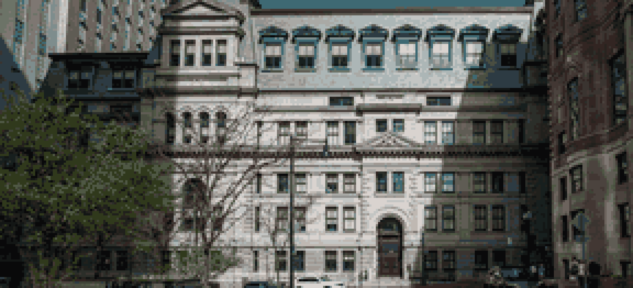 The John Adams Courthouse on Pemberton Square in Boston, a granite building with a mansard roof and an arched entrance, between taller modern towers.